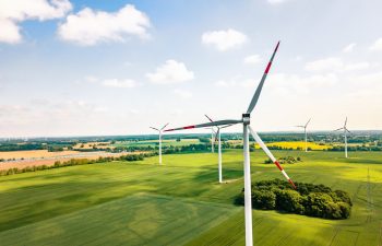 drone view on wind turbines in sunny landscape